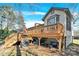 Spacious back deck features a built-in grill, a table with umbrella, and a dry storage area below at 8210 Mattingridge Dr, Charlotte, NC 28270