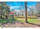 Large backyard with a playset, a grassy area, and mature trees providing plenty of shade at 8210 Mattingridge Dr, Charlotte, NC 28270