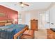 Comfortable bedroom featuring natural wood furniture, a ceiling fan, and ensuite access at 8210 Mattingridge Dr, Charlotte, NC 28270