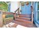 Inviting covered front porch with wooden steps and decorative flower pots at 8210 Mattingridge Dr, Charlotte, NC 28270