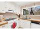 Bright kitchen features white cabinets, wood countertops, neutral backsplash and a window overlooking the backyard at 8210 Mattingridge Dr, Charlotte, NC 28270