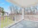 Charming outdoor balcony with white railings, offering serene views of the neighborhood and trees at 8759 Coralbell Ln, Charlotte, NC 28213