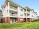 Apartment building featuring a mix of brick and vinyl siding at 8759 Coralbell Ln, Charlotte, NC 28213