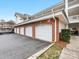 View of the garage area with brick and white doors at 8759 Coralbell Ln, Charlotte, NC 28213