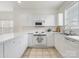 A kitchen with all-white appliances and tile flooring at 8759 Coralbell Ln, Charlotte, NC 28213