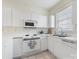 Well-lit kitchen with white cabinets, laminate countertops, and modern appliances at 8759 Coralbell Ln, Charlotte, NC 28213