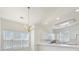 Bright kitchen featuring white cabinetry, modern appliances, and a charming gold chandelier at 8759 Coralbell Ln, Charlotte, NC 28213