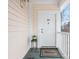 Charming porch view with welcome mat, flowers, and the unit number at 8759 Coralbell Ln, Charlotte, NC 28213