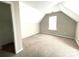 Attic space features carpet, natural light, and neutral color scheme at 9146 Austin Ridge Ln, Charlotte, NC 28214