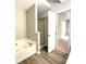 Bathroom featuring a soaking tub, shower, and modern flooring at 9146 Austin Ridge Ln, Charlotte, NC 28214