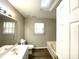 Bathroom with skylight, shower/tub combo, and neutral paint at 9146 Austin Ridge Ln, Charlotte, NC 28214