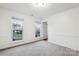 Light-filled bedroom with carpeted floors and two windows offering neighborhood views, ideal for comfort at 9146 Austin Ridge Ln, Charlotte, NC 28214