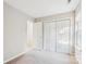 Empty bedroom with a closet, window, and access to the hallway at 9146 Austin Ridge Ln, Charlotte, NC 28214