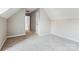 Well-lit room with neutral walls and soft carpet, enhanced by a window and featuring an access door at 9146 Austin Ridge Ln, Charlotte, NC 28214