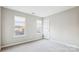 Bright bedroom features two windows and neutral walls and carpet, creating a comfortable atmosphere at 9146 Austin Ridge Ln, Charlotte, NC 28214