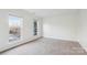 Sunlit bedroom with neutral carpet and two large windows overlooking the neighborhood at 9146 Austin Ridge Ln, Charlotte, NC 28214