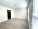 Neutral dining room featuring carpeting, natural light from a window with blinds, and wainscoting at 9146 Austin Ridge Ln, Charlotte, NC 28214