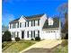 Lovely home with an attached garage and a driveway leading to the front, framed by lush greenery at 9146 Austin Ridge Ln, Charlotte, NC 28214