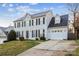 Inviting two-story home with a well-manicured lawn, complemented by a driveway and attached garage at 9146 Austin Ridge Ln, Charlotte, NC 28214