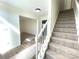 Bright foyer features neutral walls, wood-look floors, a decorative rug, and a carpeted staircase at 9146 Austin Ridge Ln, Charlotte, NC 28214