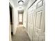 Hallway with neutral walls and several doors at 9146 Austin Ridge Ln, Charlotte, NC 28214