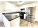 Renovated kitchen with stainless steel refrigerator, black oven, and white cabinetry at 9146 Austin Ridge Ln, Charlotte, NC 28214