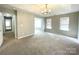 Spacious living room with large windows and a modern light fixture at 9146 Austin Ridge Ln, Charlotte, NC 28214