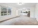 Open-concept living room with views of the kitchen area featuring white cabinets and stainless steel appliances at 9146 Austin Ridge Ln, Charlotte, NC 28214