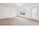 Inviting living room with neutral carpet, white walls, and natural light from the window provides a blank canvas at 9146 Austin Ridge Ln, Charlotte, NC 28214