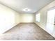 Spacious living room featuring carpeting, neutral walls, natural light, and a door at 9146 Austin Ridge Ln, Charlotte, NC 28214