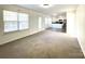 Open-concept living room featuring carpeting, neutral walls, natural light, and an eat-in kitchen at 9146 Austin Ridge Ln, Charlotte, NC 28214