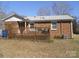 Brick home featuring an inviting back deck, enhancing the outdoor living space at 9808 Arbor Dale Ave, Charlotte, NC 28215