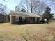 Charming brick home with black shutters and a well-maintained front yard at 9808 Arbor Dale Ave, Charlotte, NC 28215