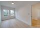 Minimalist bedroom with wood floors and two windows for natural light at 0004 Mission Church Rd, Locust, NC 28097