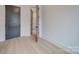 Bedroom featuring light wood floors, white walls, and door at 0004 Mission Church Rd, Locust, NC 28097