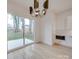 Dining area features sliding glass doors to the backyard and modern light fixture at 0004 Mission Church Rd, Locust, NC 28097