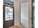 Bright entryway with hardwood floors, a stylish front door, and an open doorway to the next room at 0004 Mission Church Rd, Locust, NC 28097