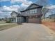 Beautiful two-story home featuring a dark gray exterior and a spacious two-car garage at 0004 Mission Church Rd, Locust, NC 28097