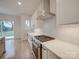 Modern kitchen featuring stainless steel appliances, white cabinets, and a sleek range hood at 0004 Mission Church Rd, Locust, NC 28097