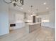 Bright, open kitchen featuring an island, stainless steel appliances, and modern pendant lighting at 0004 Mission Church Rd, Locust, NC 28097