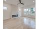 Bright living room with a modern fireplace and large windows, showcasing natural light and sleek design at 0004 Mission Church Rd, Locust, NC 28097