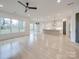 Bright open-concept living space with light wood floors flowing into modern kitchen at 0004 Mission Church Rd, Locust, NC 28097