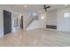 Open-concept living room with hardwood floors, a modern fireplace, and a staircase leading to the upper level at 0004 Mission Church Rd, Locust, NC 28097