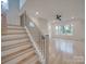 Open wood staircase with black metal railing leading to the upstairs living space at 0004 Mission Church Rd, Locust, NC 28097