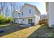 The backyard features a sliding glass door to a small patio and grassy area at 1008 Beaugard Dr, Charlotte, NC 28208