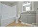 Nicely finished bathroom features a granite countertop and tub with shower at 1008 Beaugard Dr, Charlotte, NC 28208