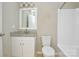 Updated bathroom with granite vanity, white cabinets, and shower and tub combination at 1008 Beaugard Dr, Charlotte, NC 28208