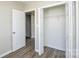 Bedroom featuring a walk-in closet, wood-look flooring, and neutral paint at 1008 Beaugard Dr, Charlotte, NC 28208