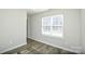 This bedroom offers ample natural light, wood-look flooring, and neutral paint at 1008 Beaugard Dr, Charlotte, NC 28208