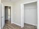 This bedroom features a walk-in closet, wood-look flooring, and neutral paint at 1008 Beaugard Dr, Charlotte, NC 28208